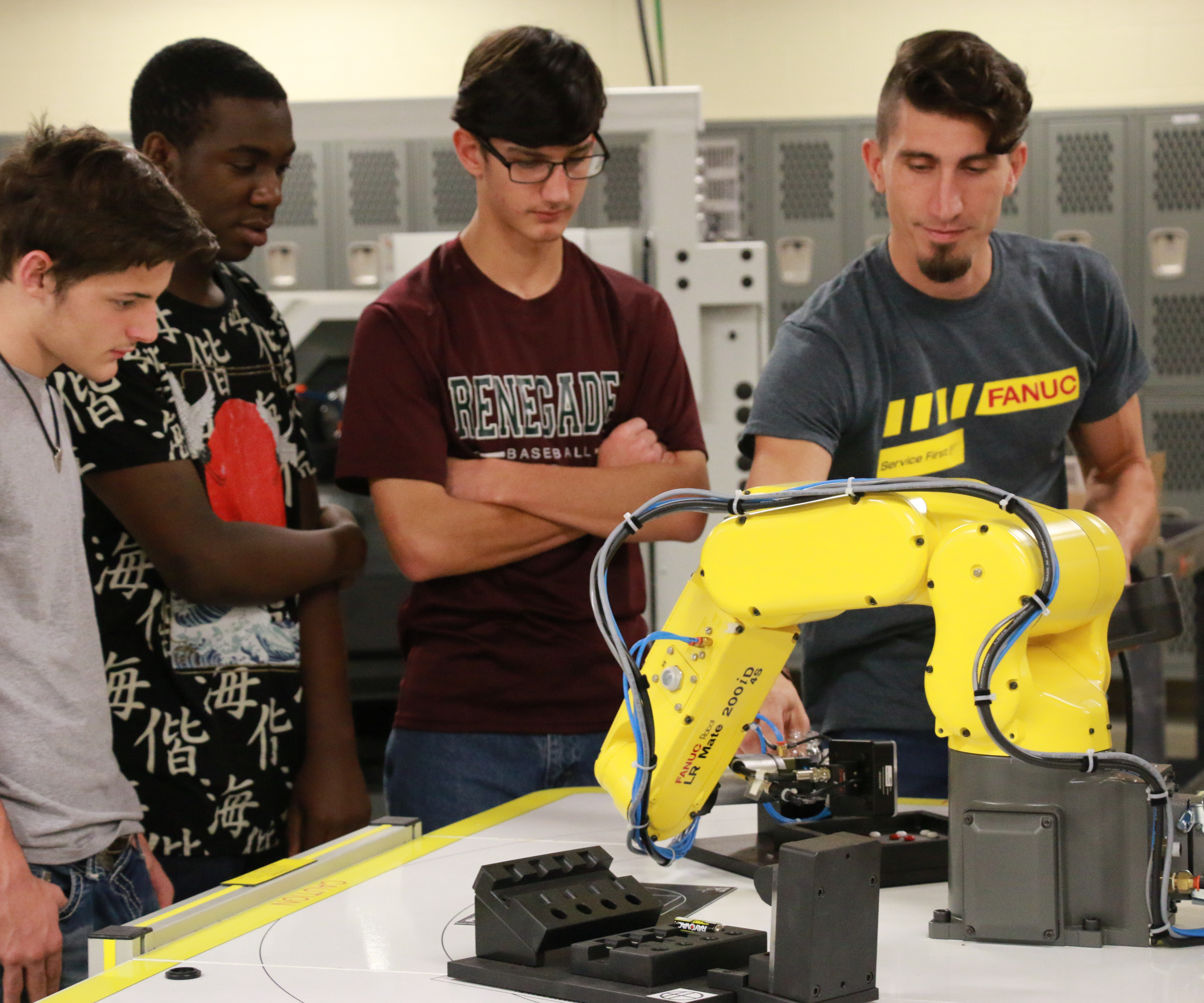 Students learning how to operate a piece of equipment