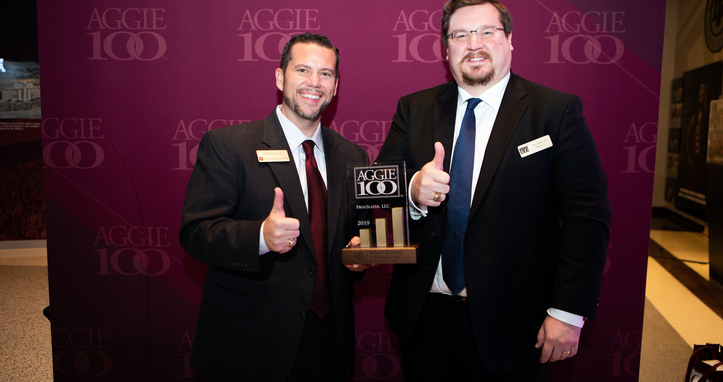 Ross Morel accepting an Aggie 100 award